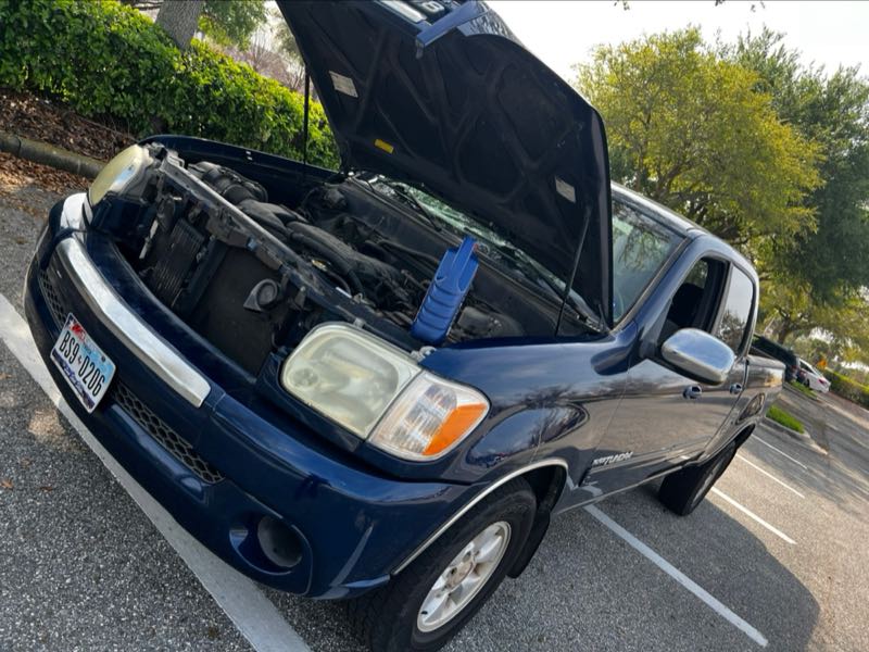 Engine service on a pickup truck with the hood raised